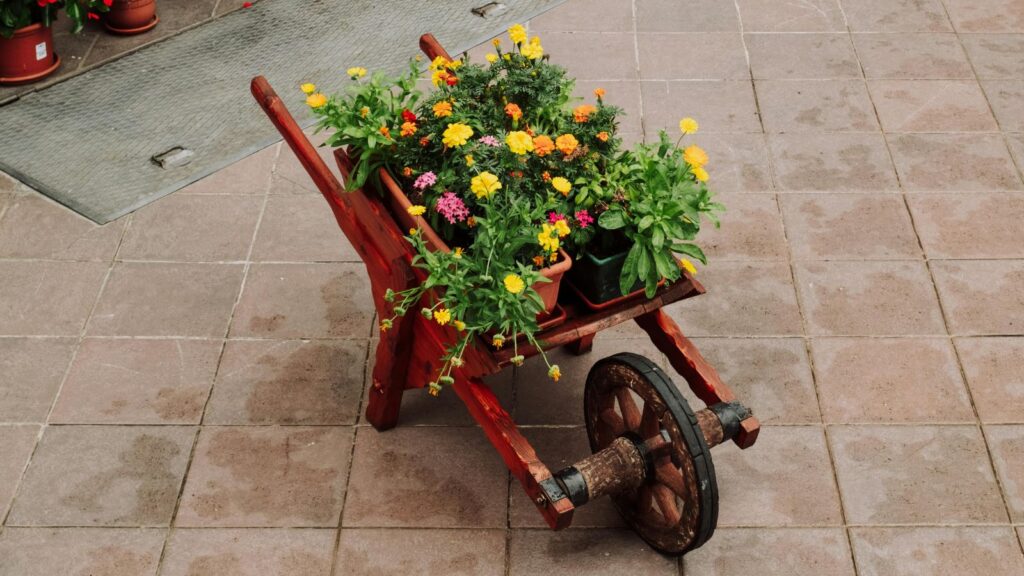 A wooden wagon carrying different flowers.