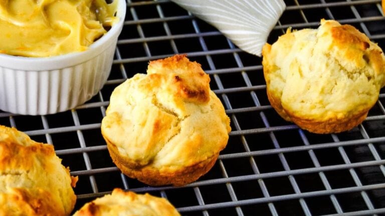 Golden clementine drop biscuits on a cooling rack.