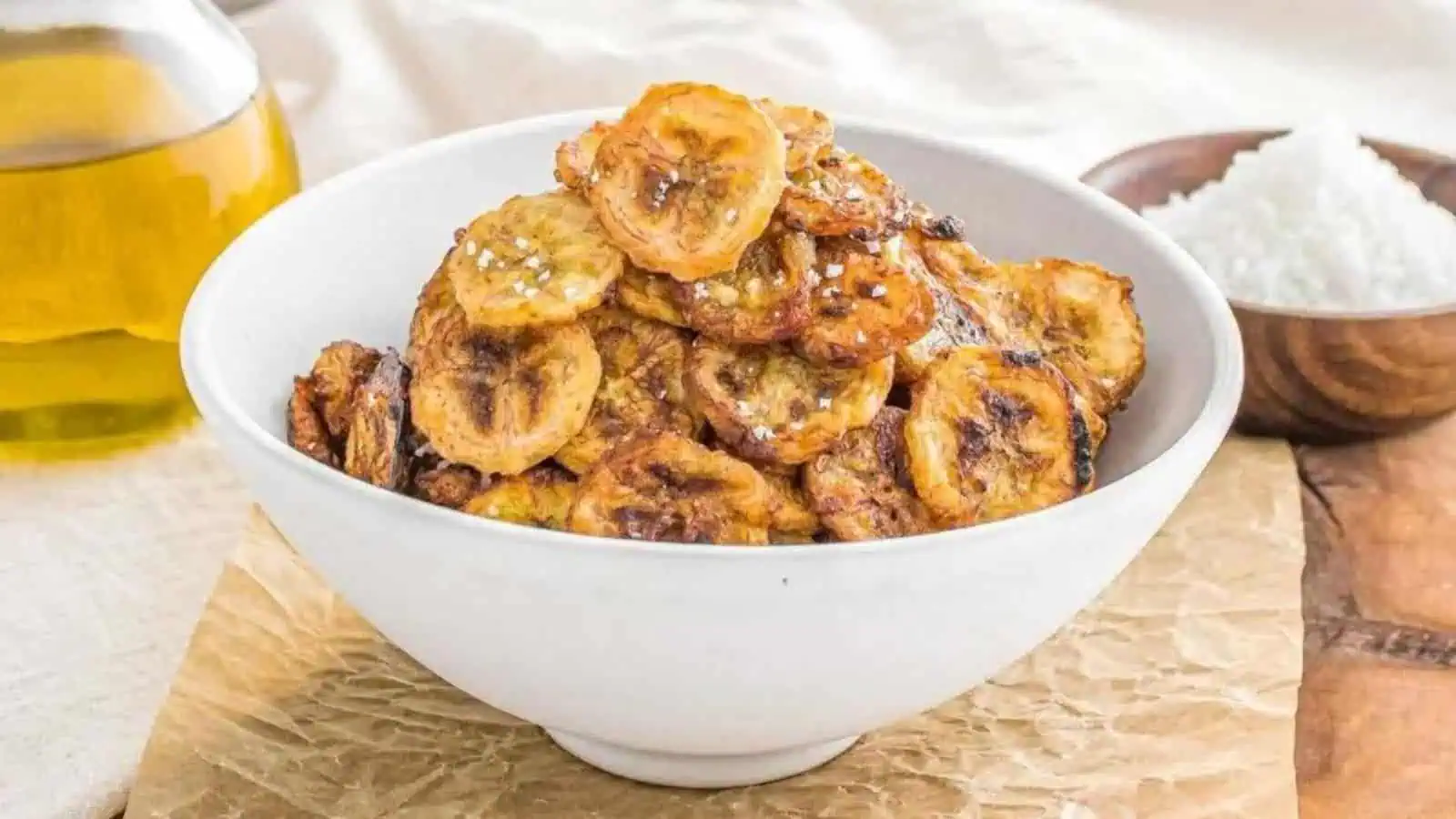 Air Fried babana chips on a white bowl.