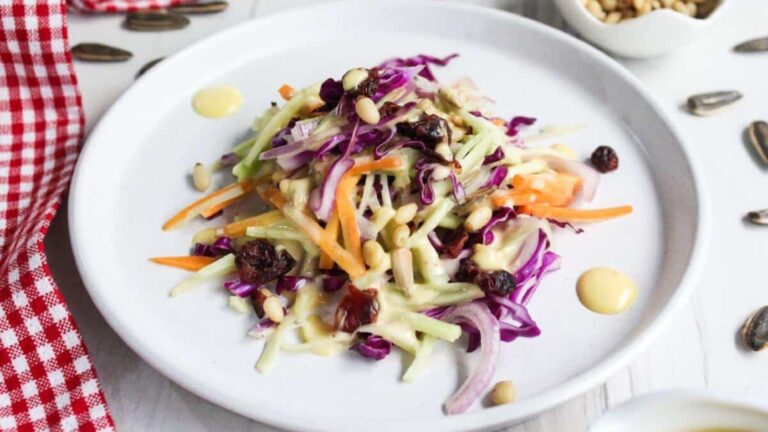 A plate of broccoli slaw with a dressing on it.