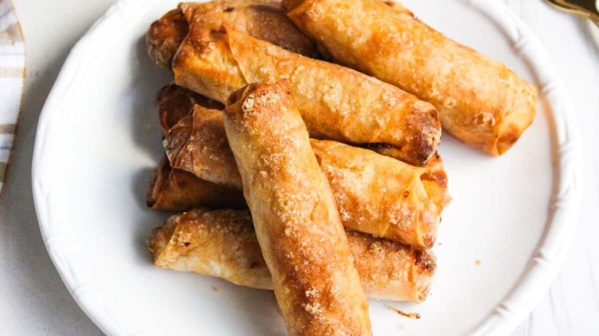 Fried Filipino banana turon lumpia on a white plate.