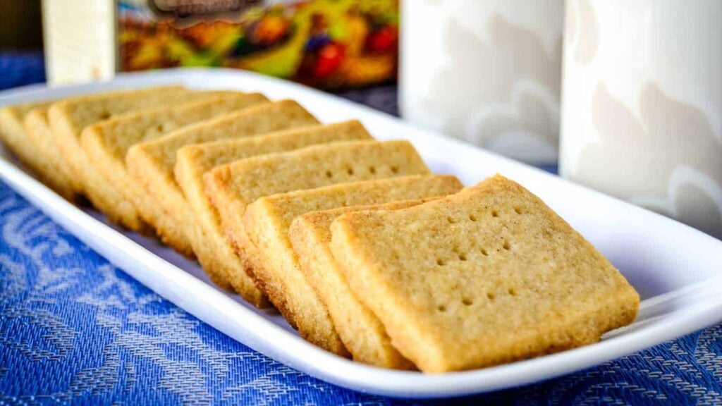 A white plate of a line of Spiced Shortbread Cookies lined up.