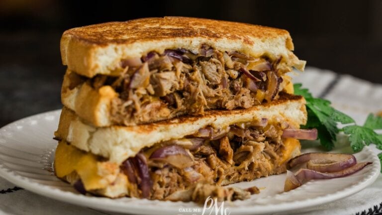A stack of pulled pork grilled cheese on a plate.