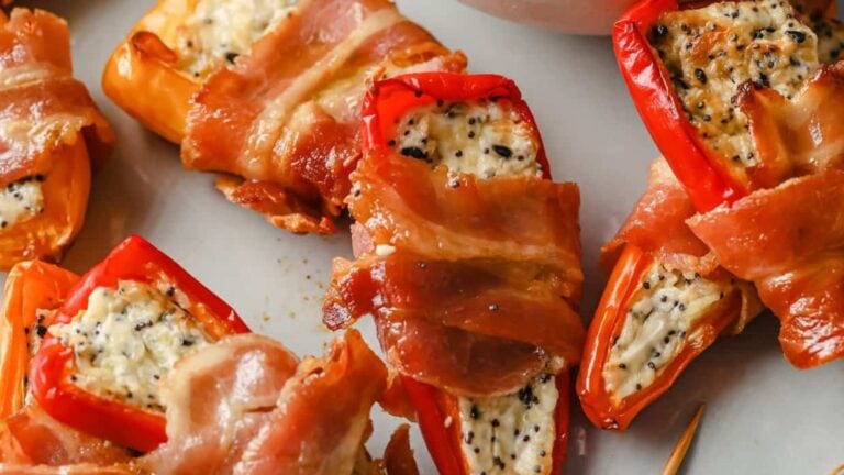 A plate of bacon wrapped mini peppers.