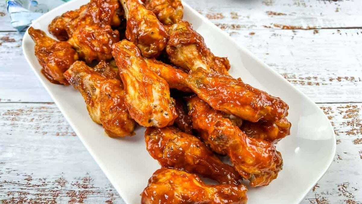 Ninja Woodfire Grill Wings with Jack Daniel's BBQ Sauce on a white plate.