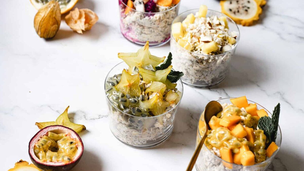 Four combinations of vegan overnight oats with fruit.