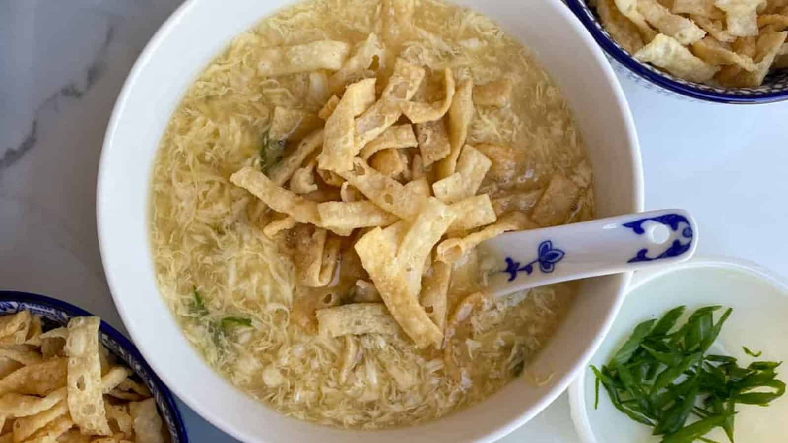 Classic Chinese egg drop soup with silky egg ribbons in white bowls.
