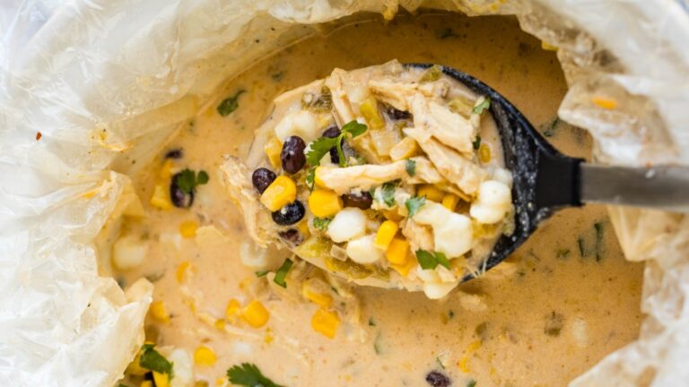 A bowl of mexican chicken chowder with corn and black beans.