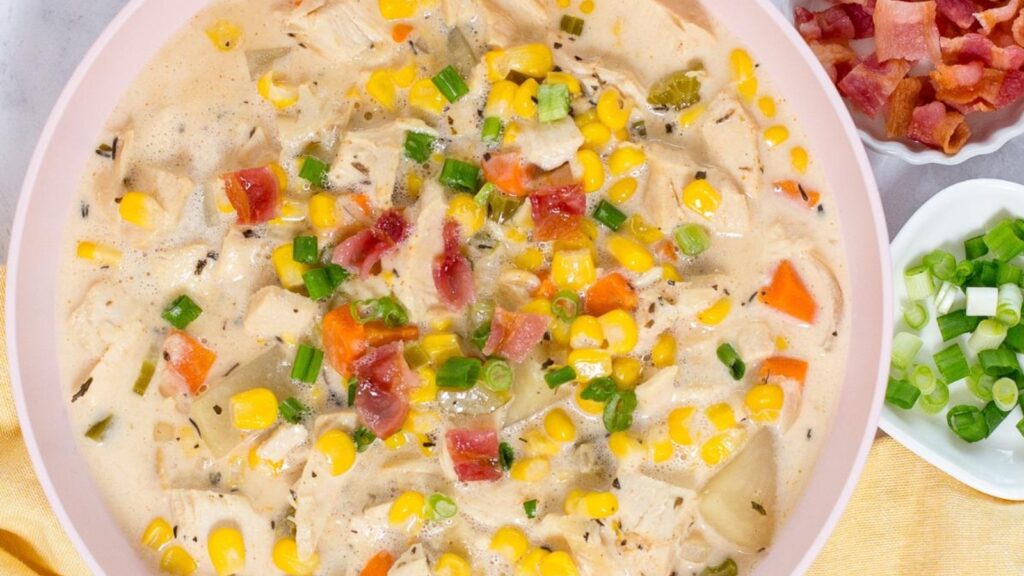A bowl of creamy crock pot chicken corn soup with a rich, creamy texture.
