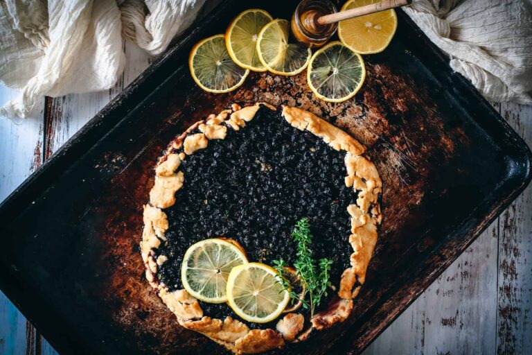 Blueberry galette with lemon slices on top.