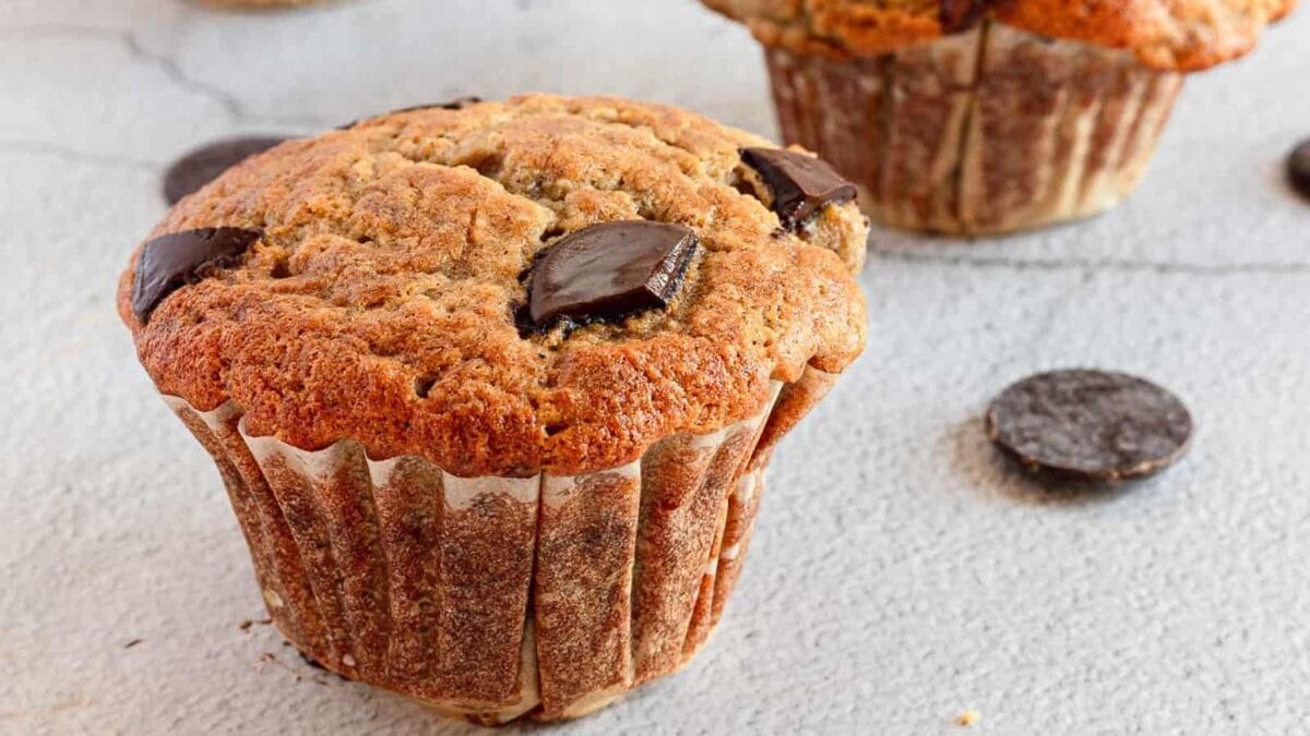 Gluten-free banana chocolate chip muffins on a surface.