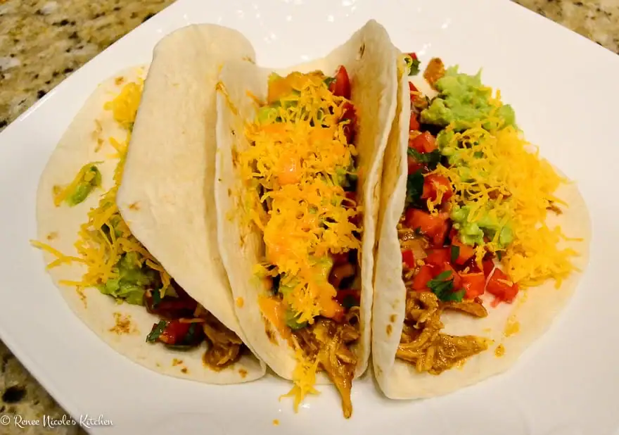 Three Chicken Tacos on a plate.