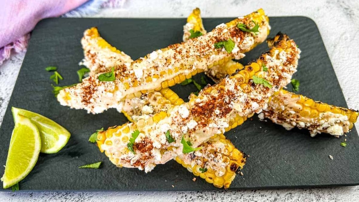Grilled Elote Corn Ribs on a black platter.