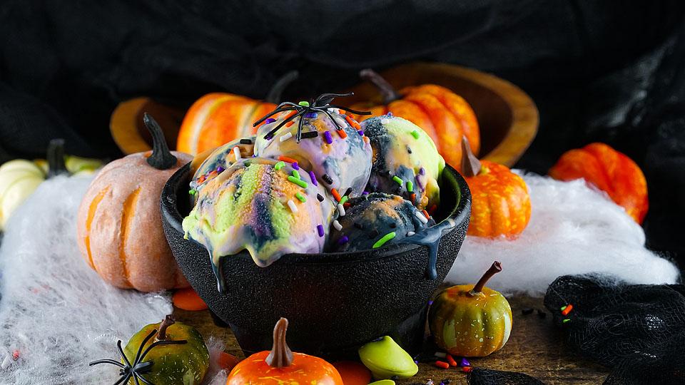 Colorful no-churn Halloween ice cream swirled with orange, purple, and black.