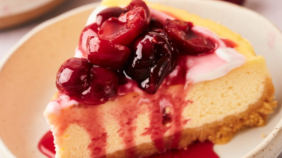 A slice of cherry cheesecake on a plate.