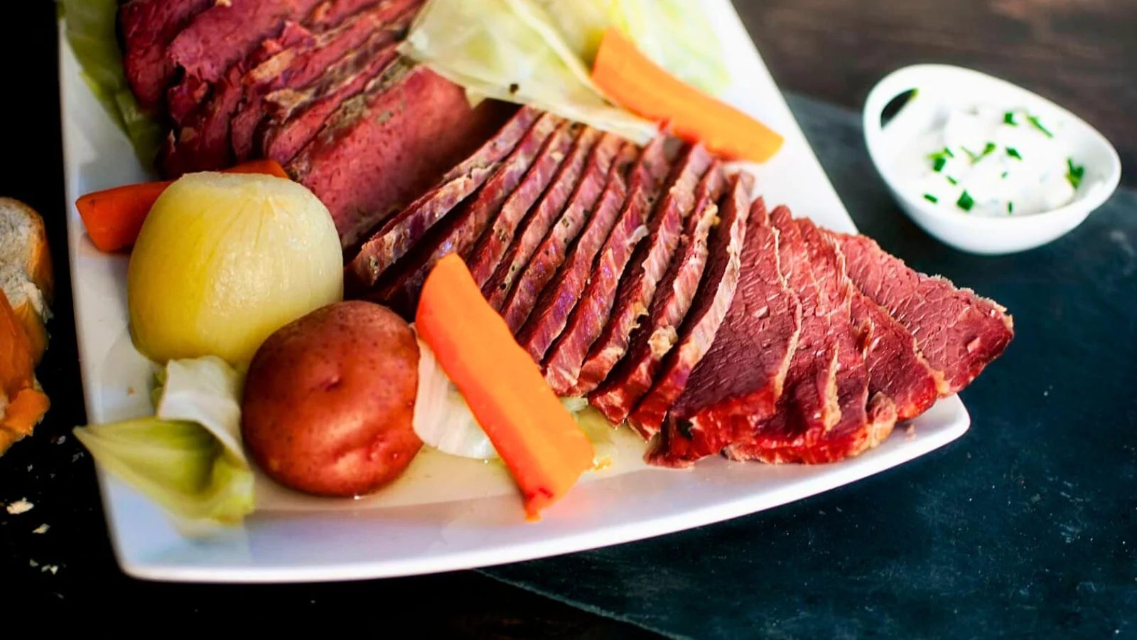 Corned beef and cabbage with potatoes and carrots served on a platter.