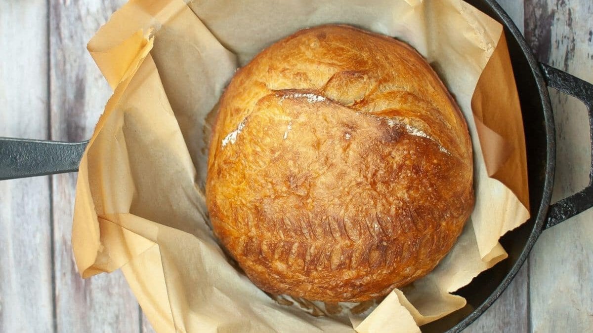 Two pieces of dutch oven sourdough bread on a plate.